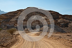 Gravel road and mountain landscape in Oman