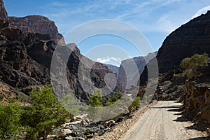 Gravel road and mountain landscape in Oman`s Wadi Arbiyeen