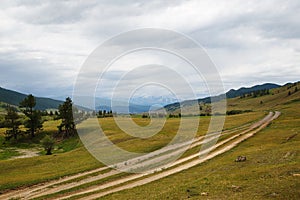 Gravel road in a mountain valley at the top of the Altai Mountains