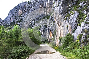 Gravel road through mountains and trees, Omis, Croatia