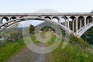 A gravel road runs under the Rogue River Bridge at Gold Beach, Oregon, USA