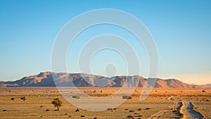 Gravel road to a spectacular mountain in Aus, Namibia.