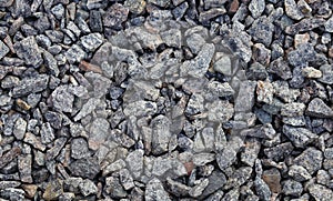 Gravel stone used to cover road surfaces.stone texture, background in black, gray and white tone, rock stone road.