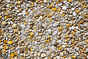 Gravel with white and yellow pebbles/texture background