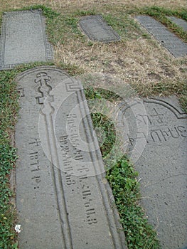 Graven ancient tomb stones on the earth in Armenia .