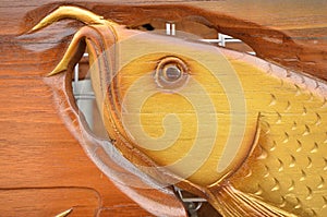 Graven arowana fish head on the wood
