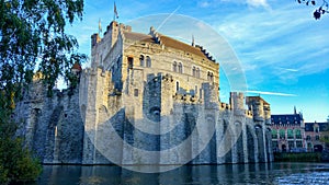 Gravensteen or Castle of the Counts, famous medieval monument in Ghent, Belgium, with Lieve river around