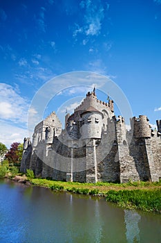 Gravensteen castle reflecting in river, Belgium