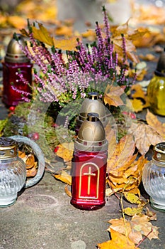 Graves decorations: flowers and votive candles.