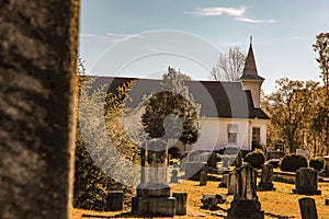 Graveyard and headstones and a little white church in the background