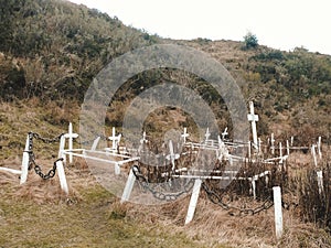 Graveyard in Puerto de Hambre, Punta Arenas, Chile with Pringles Stokes grave surrounded by greenery photo