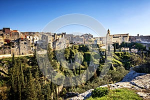 Gravina in Puglia: picturesque landscape of the the deep ravine and the old town with the ancient cathedral, Bari, Italy