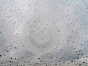 Gray abstract background with raindrops on glass