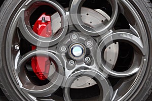 Gray alloy sports car wheel and disc brake close-up