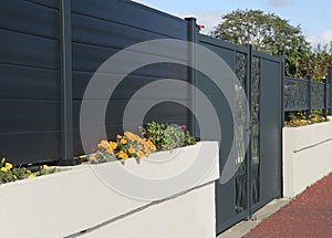 Gray aluminum gate and screens for a house