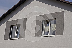 Gray attic of a private house with two windows