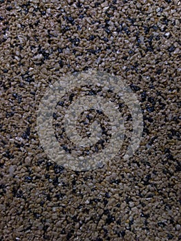 Gray background of many small stones in close-up. Abrasive surface.