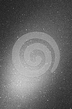 Gray background with sparkles and spot of light