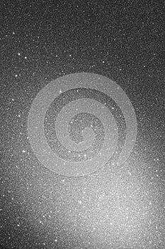 Gray background with sparkles and spot of light