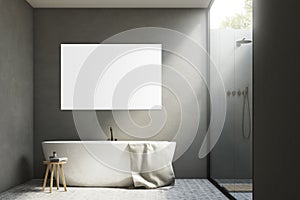 Gray bathroom with a tub and poster