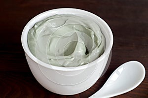 Gray bentonite clay in a bowl. Diy facial mask and body wrap recipe.