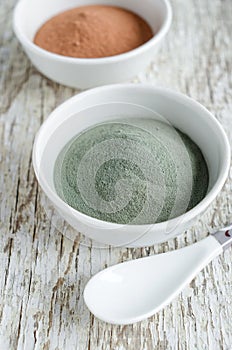 Gray bentonite clay powder in the white bowl. Diy facial mask and body wrap recipe. Natural beauty treatment and spa