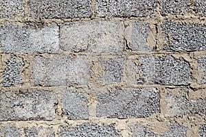Gray block wall. Rough surface.