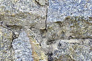 Gray blue old wall made of colored stones and cement