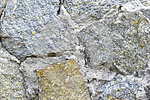 Gray blue old wall made of colored stones and cement