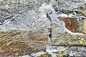 Gray blue old wall made of colored stones and cement