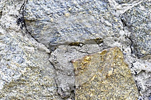 Gray blue old wall made of colored stones and cement