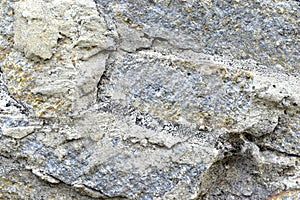 Gray blue old wall made of colored stones and cement