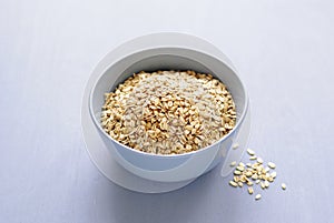 Gray bowl of dry oatmeal