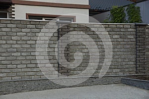 brick fence on a rural street photo