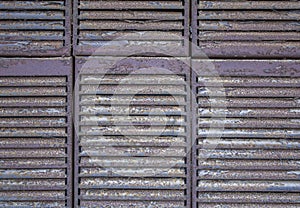 Gray brown metal rusty jalousie lattice close-up. rough surface texture