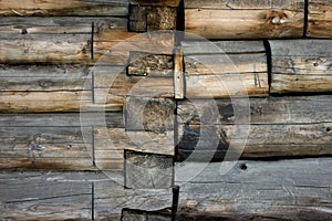 Gray brown old log wall, background with wood texture