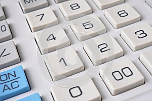 Gray calculator keyboard buttons close up. Light background or wallpaper. Economy, finance, money, commerce. Bank, credit, loan,