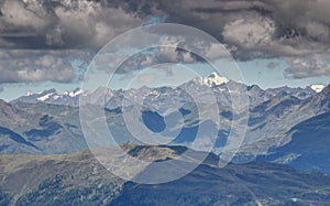 Gray clouds over sunny ridges snowy peaks High Tauern Austria