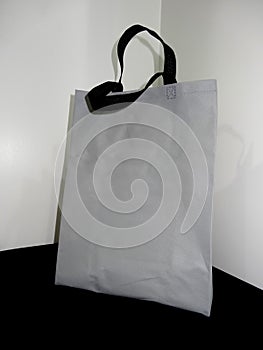 Gray color bag and black handle, Non woven Bag, Polypropylene Non Woven Bag on table