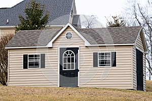 Gray color prefab gardening tools storage shed in the house backyard