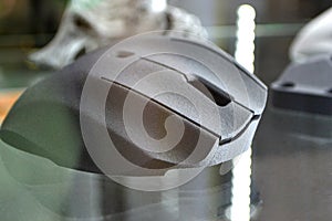 Gray computer mouse printed on 3D printer. Model printed on 3D printer