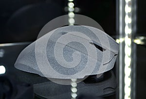 Gray computer mouse printed on 3D printer. Model printed on 3D printer