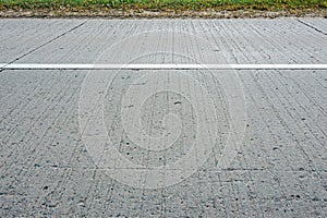 Gray concrete country road. closeup side view