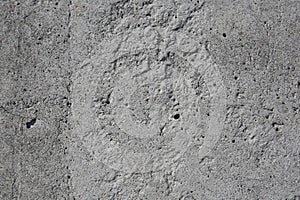 A gray concrete surface with small defects