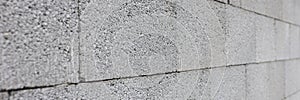 Gray concrete wall made of rectangular blocks photo