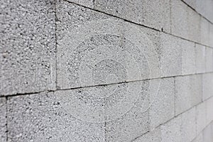 Gray concrete wall made of rectangular blocks photo