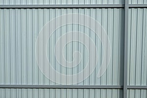 Gray corrugated metal fence. Part of the fence