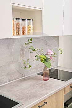 gray countertop and splashback, light wood kitchen cabinets