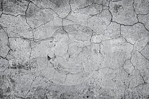Gray cracked stucco, concrete and cement wall pattern. Asymmetric and abstract broken on textured Background.