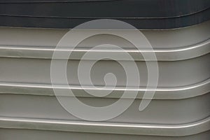 Gray dark plastic texture from a row of boxes